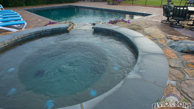 Built-in spa with bluestone coping and natural stone.