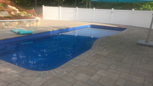 In-ground pool and Unilock patio in Medway, MA.