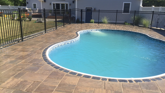 Paver patio and in-ground liner pool coping.