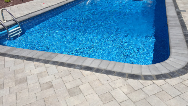 Unilock paver patio installation in Johnston, RI with pool coping.