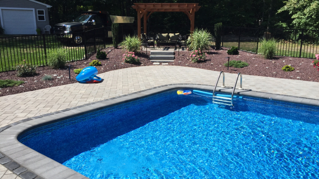 Unilock paver patio installation in Johnston, RI with pool coping.