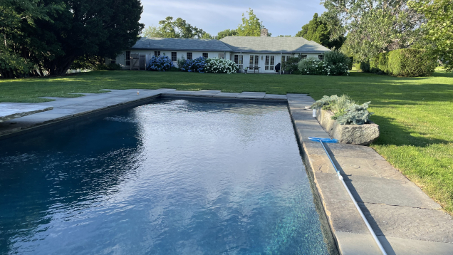 A view of the gunite pool with the house in the background.
