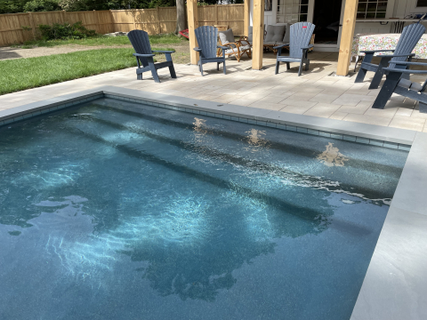 A dark StoneScapes finish in a gunite pool installed by Elvio and Sons